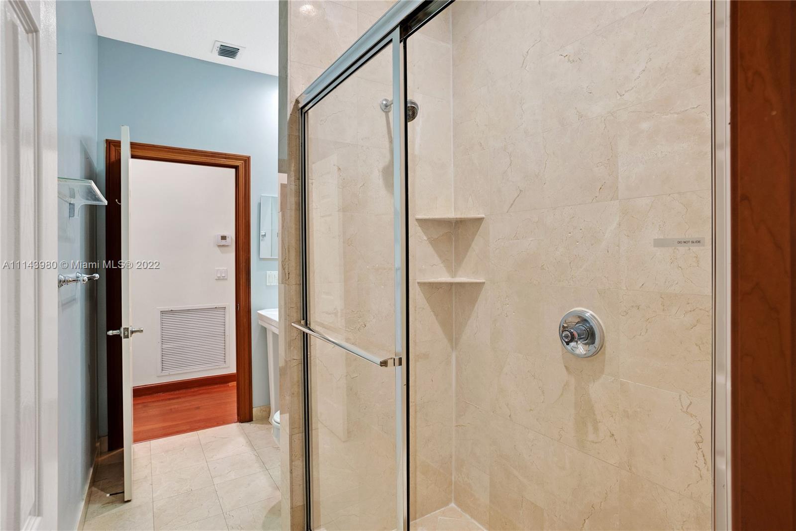 323 Cardinal Avenue Boca Raton, FL 33486 - Photo 33 of 56 a bathroom with a shower and a glass door