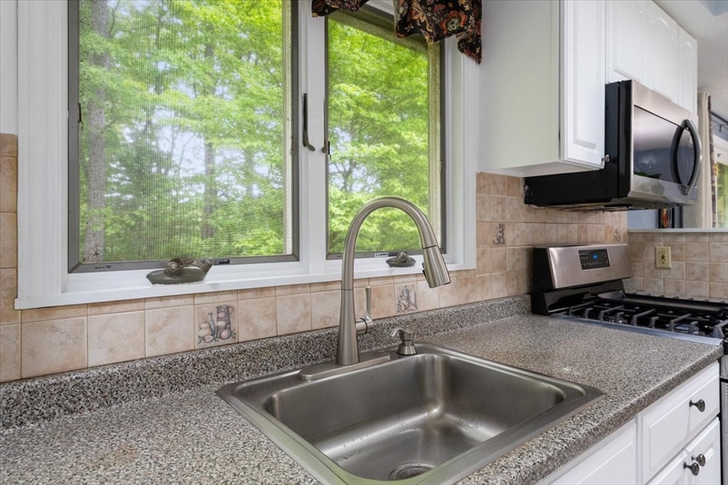 4 Hitchinpost Road Chelmsford, MA 01824 - Photo 8 of 25 a kitchen with a sink a counter top space and a window