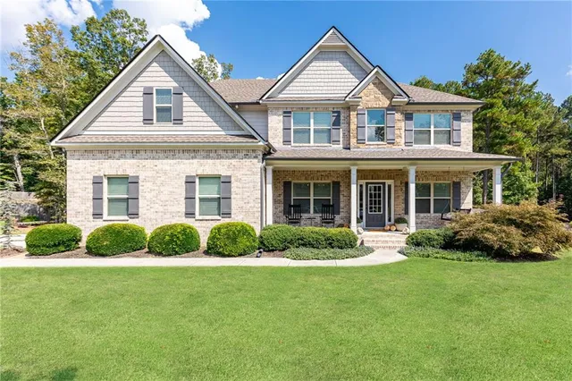 a front view of a house with a yard