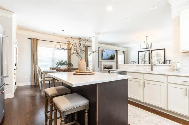 a view of kitchen with sink dining table and chairs
