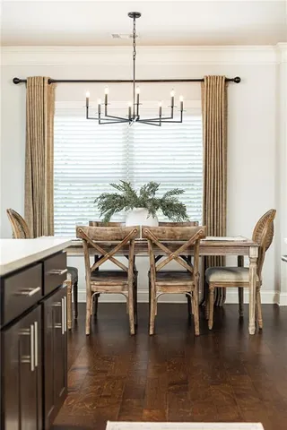 a dining room with furniture and wooden floor