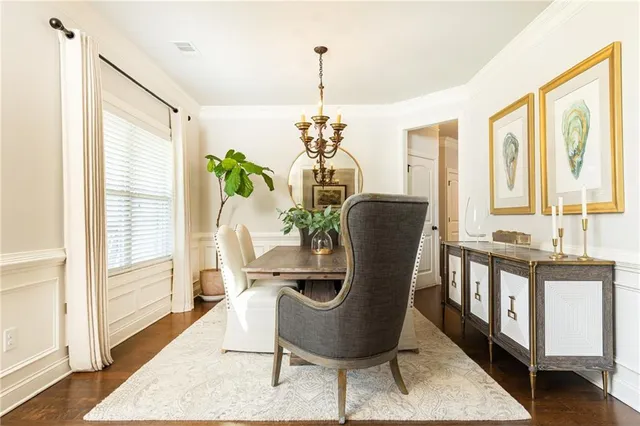 a dining room with furniture a chandelier and wooden floor