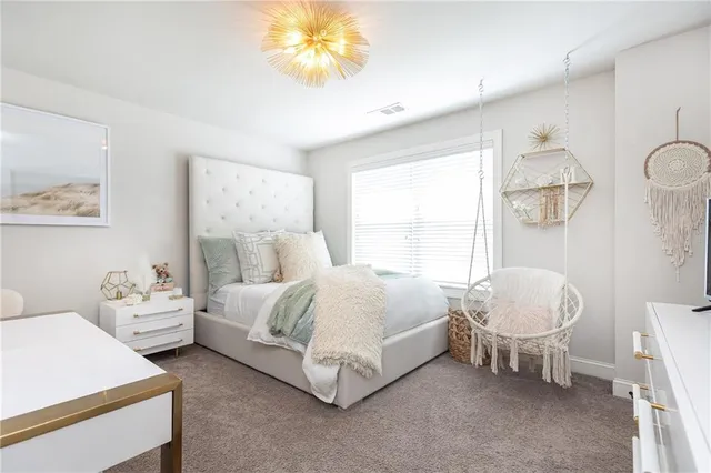 a spacious bedroom with a bed and a chandelier