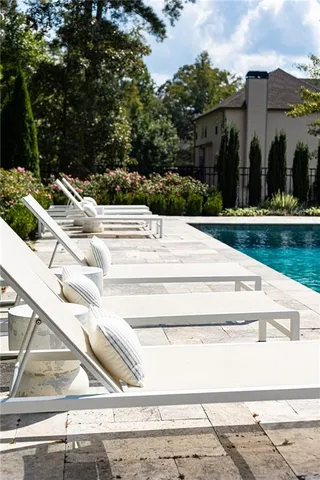a view of swimming pool and outdoor seating