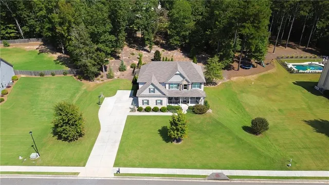 an aerial view of a house with swimming pool