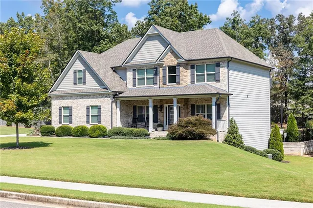 a front view of a house with garden