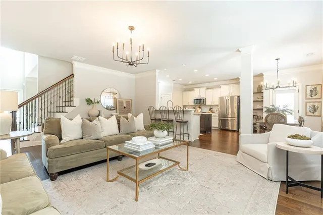 a living room with furniture and a chandelier