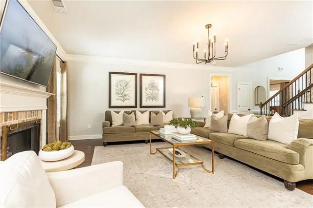 a living room with furniture and a fireplace