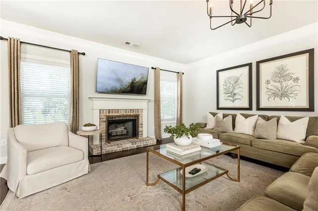 a living room with furniture a large window and a fireplace