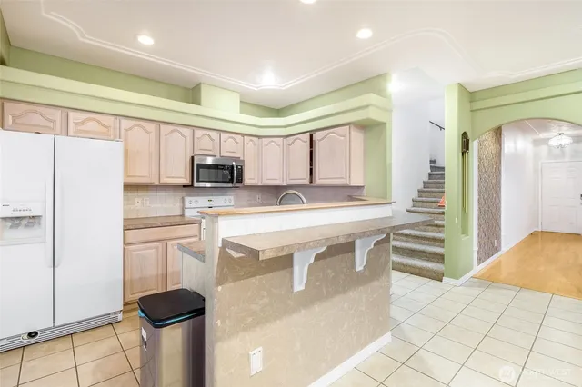 a kitchen with stainless steel appliances a stove a sink and a refrigerator