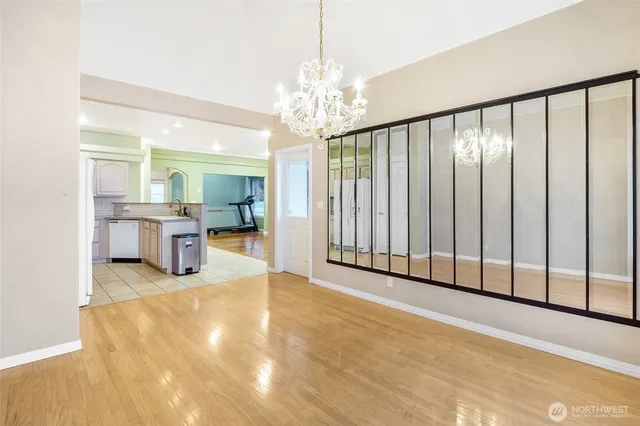 a view of a big room with windows and chandelier