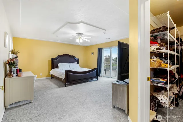 a living room with furniture and a book shelf