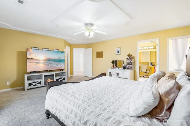 a bedroom with a bed and a flat screen tv