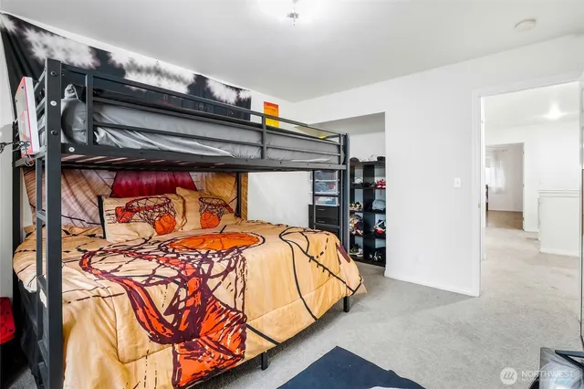 a bed sitting in a bedroom next to a window