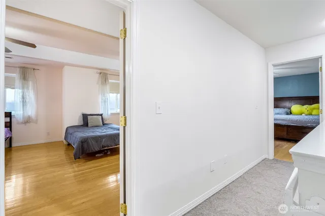 a bedroom with a bed and a view of living room