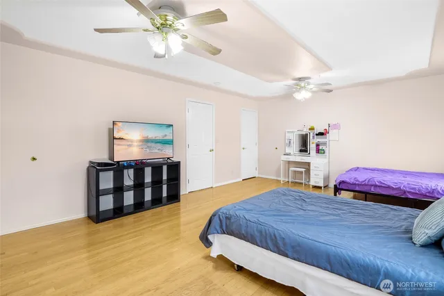 a bedroom with a bed and a flat screen tv