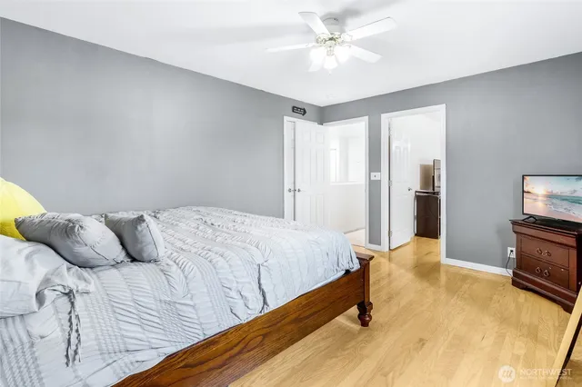 a bedroom with a bed and a flat screen tv