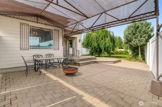 a view of a patio with table and chairs and potted plants