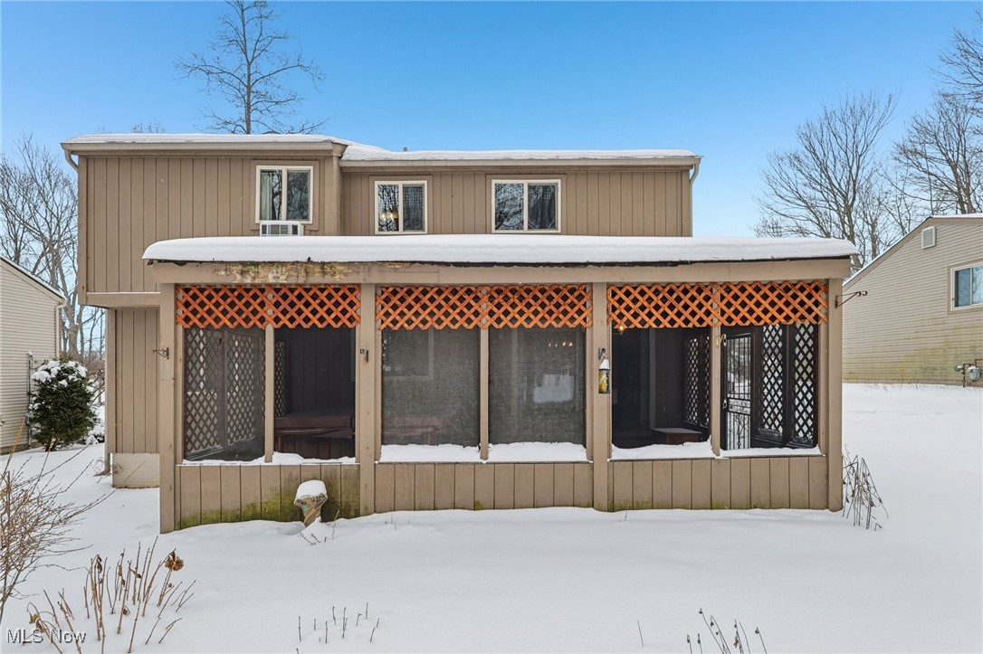 751 Bacon Road Painesville, OH 44077 - Photo 46 of 50 Snow covered back of property featuring a sunroom