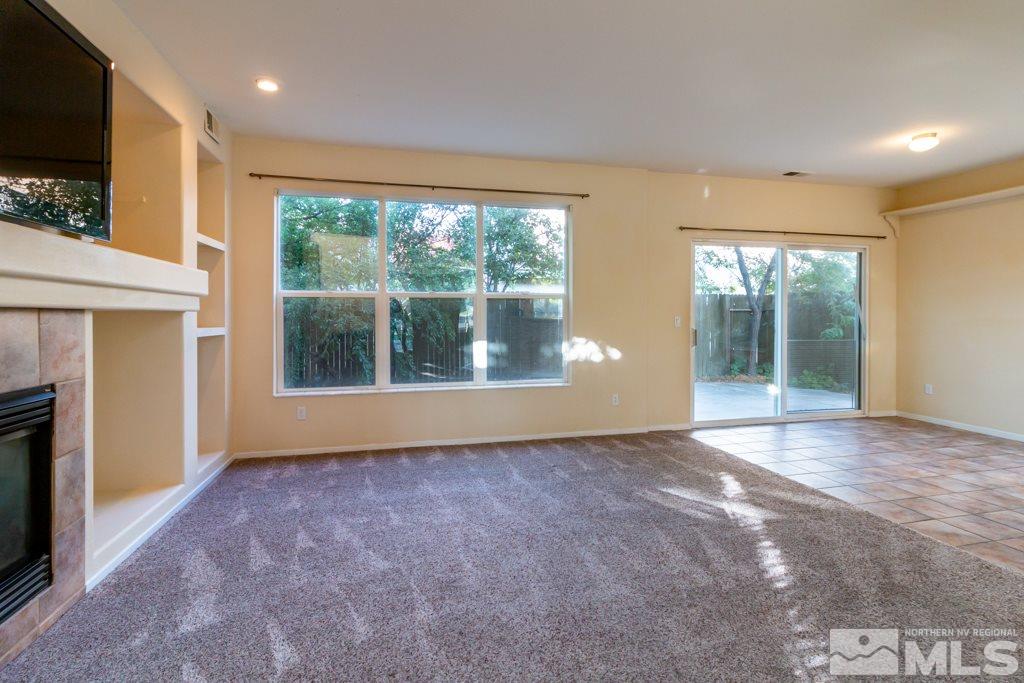 9630 Truckee Meadows Place Reno, NV 89521 - Photo 4 of 18 a view of an empty room with wooden floor and a window