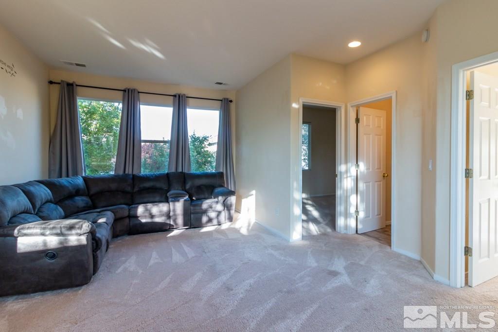 9630 Truckee Meadows Place Reno, NV 89521 - Photo 7 of 18 a living room with furniture and large windows