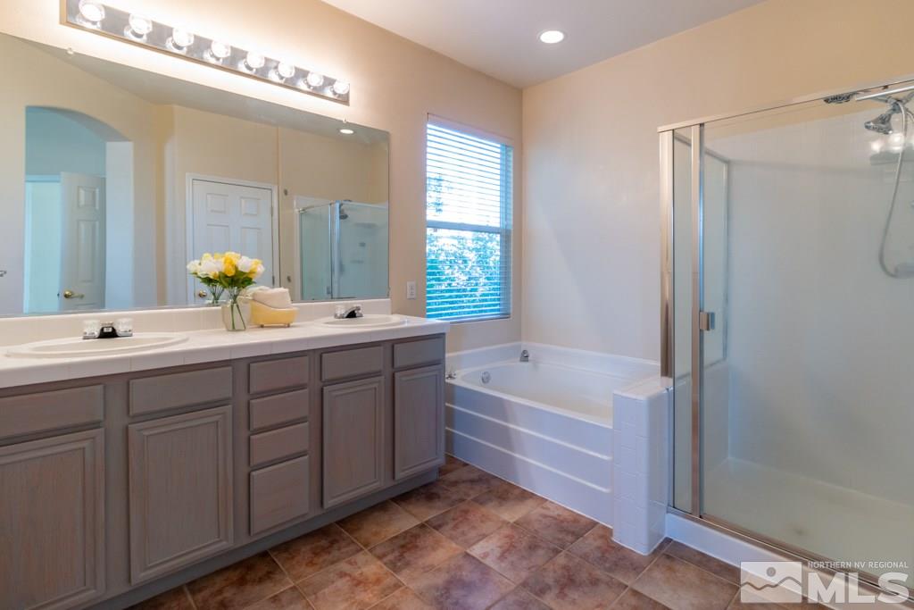 9630 Truckee Meadows Place Reno, NV 89521 - Photo 9 of 18 a bathroom with a tub sink double and mirror