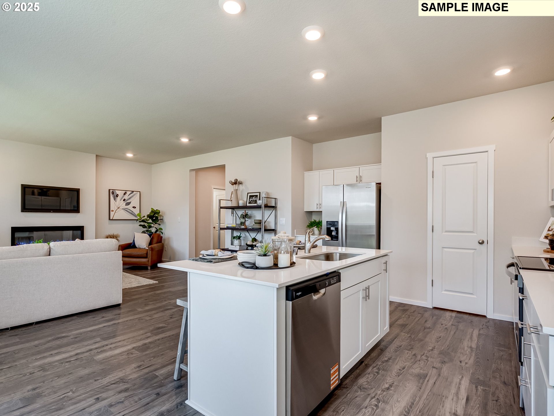 155 Northwest 30th Street Battle Ground, WA 98604 - Photo 11 of 36 a kitchen that has a lot of cabinets a sink and wooden floor