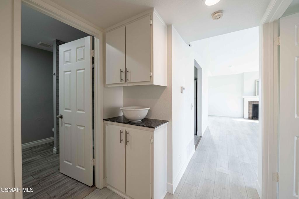1718 Sinaloa Road, Unit 219 Simi Valley, CA 93065 - Photo 14 of 41 a kitchen with white cabinets and refrigerator