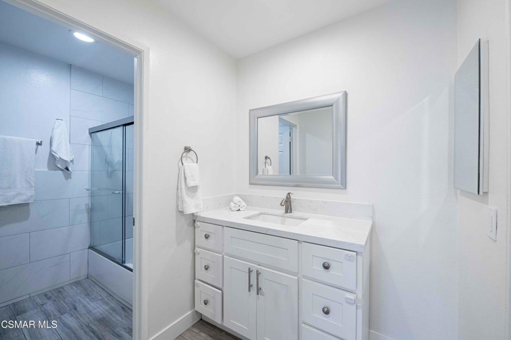 1718 Sinaloa Road, Unit 219 Simi Valley, CA 93065 - Photo 17 of 41 a bathroom with a double vanity sink and mirror