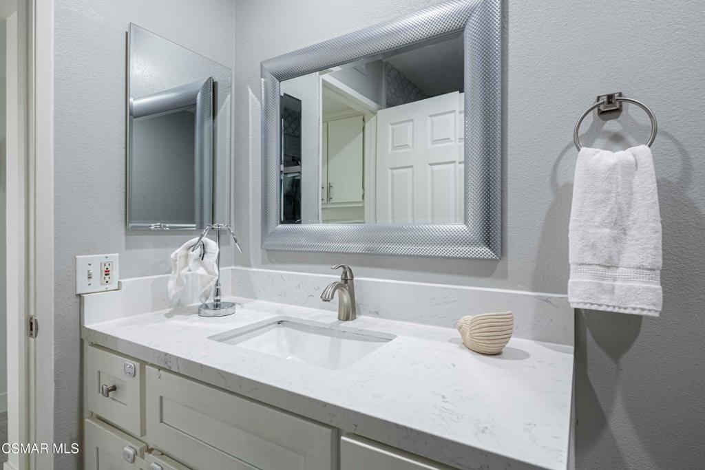 1718 Sinaloa Road, Unit 219 Simi Valley, CA 93065 - Photo 22 of 41 a bathroom with a sink and a mirror