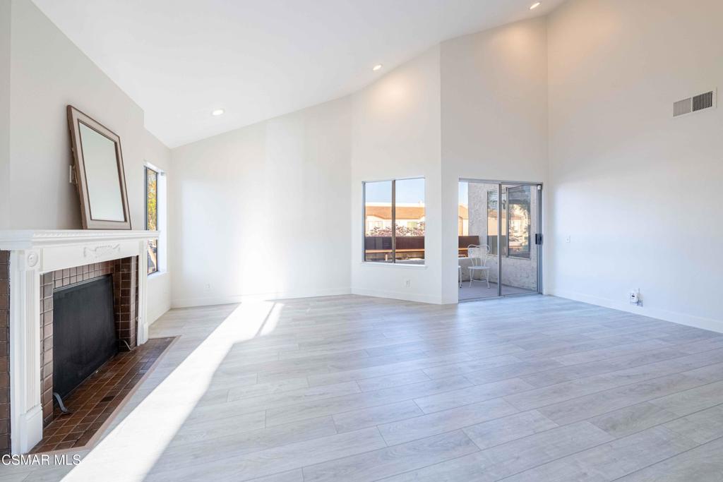 1718 Sinaloa Road, Unit 219 Simi Valley, CA 93065 - Photo 4 of 41 a view of an empty room with glass door and wooden floor
