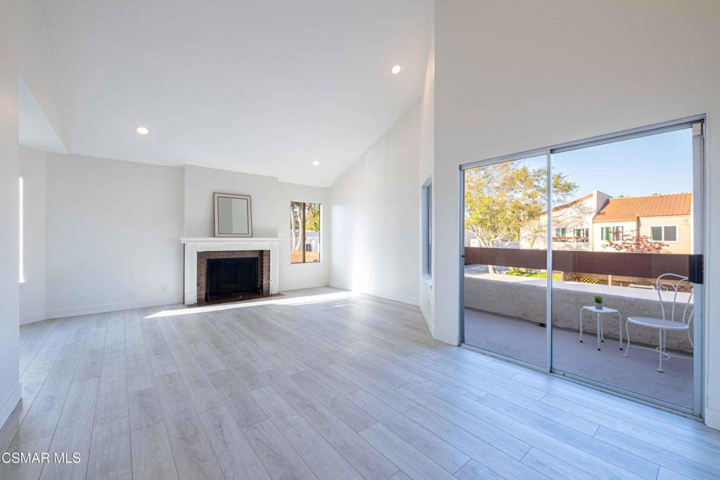 1718 Sinaloa Road, Unit 219 Simi Valley, CA 93065 - Photo 5 of 41 a view of empty room with wooden floor and fireplace