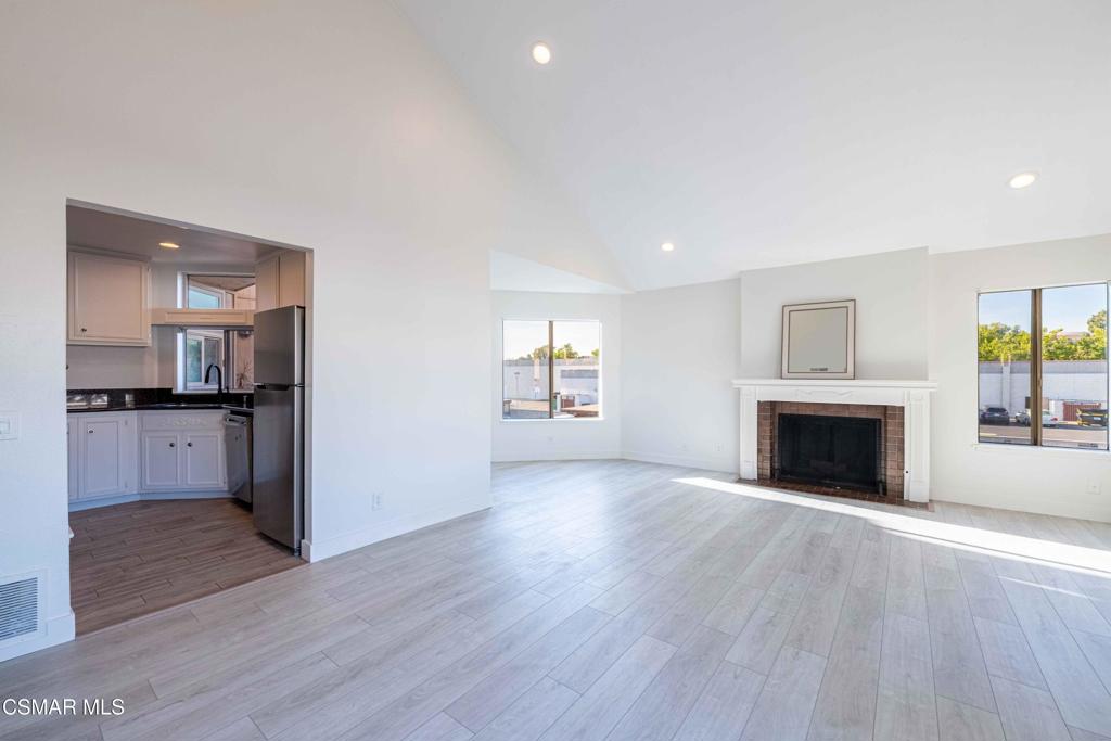 1718 Sinaloa Road, Unit 219 Simi Valley, CA 93065 - Photo 7 of 41 an empty room with wooden floor fireplace and windows