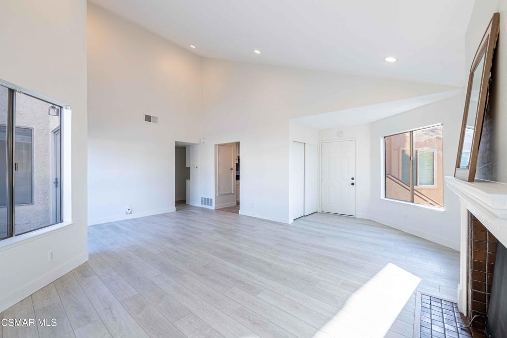 1718 Sinaloa Road, Unit 219 Simi Valley, CA 93065 - Photo 8 of 41 a view of an empty room with wooden floor and a window