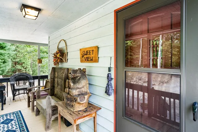 a living room with furniture a fireplace and a floor to ceiling window