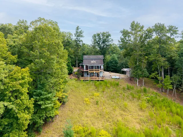 a view of a house with a yard balcony and sitting area