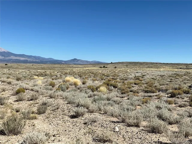 a view of a large mountain with mountains in the background