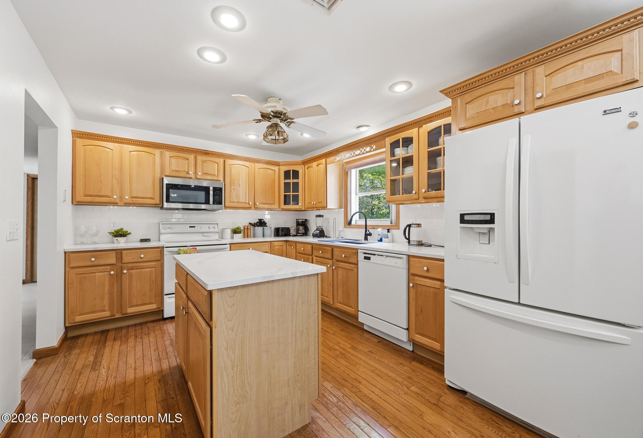 58 Bender Road Gouldsboro, PA 18424 - Photo 11 of 55 a kitchen with a refrigerator a sink and dishwasher with wooden floor