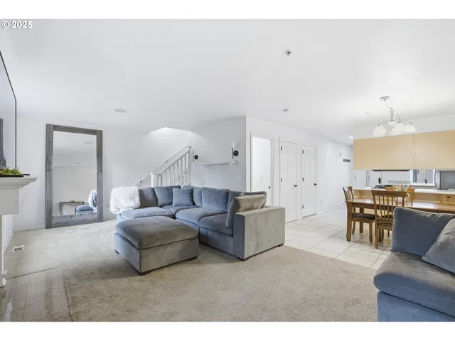 a living room with furniture and a dining table