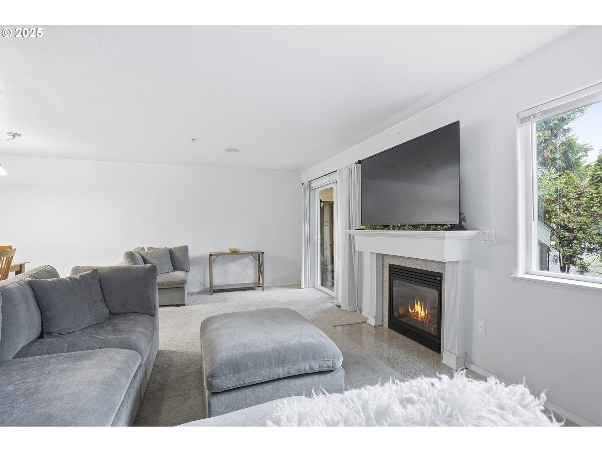 445 Harris Lane Oregon City, OR 97045 - Photo 14 of 29 a living room with furniture a fireplace and a flat screen tv