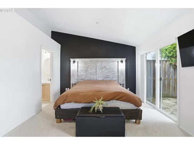 a bed room with a bed and a television