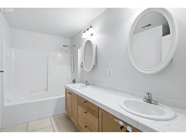 a bathroom with a sink double vanity and a mirror