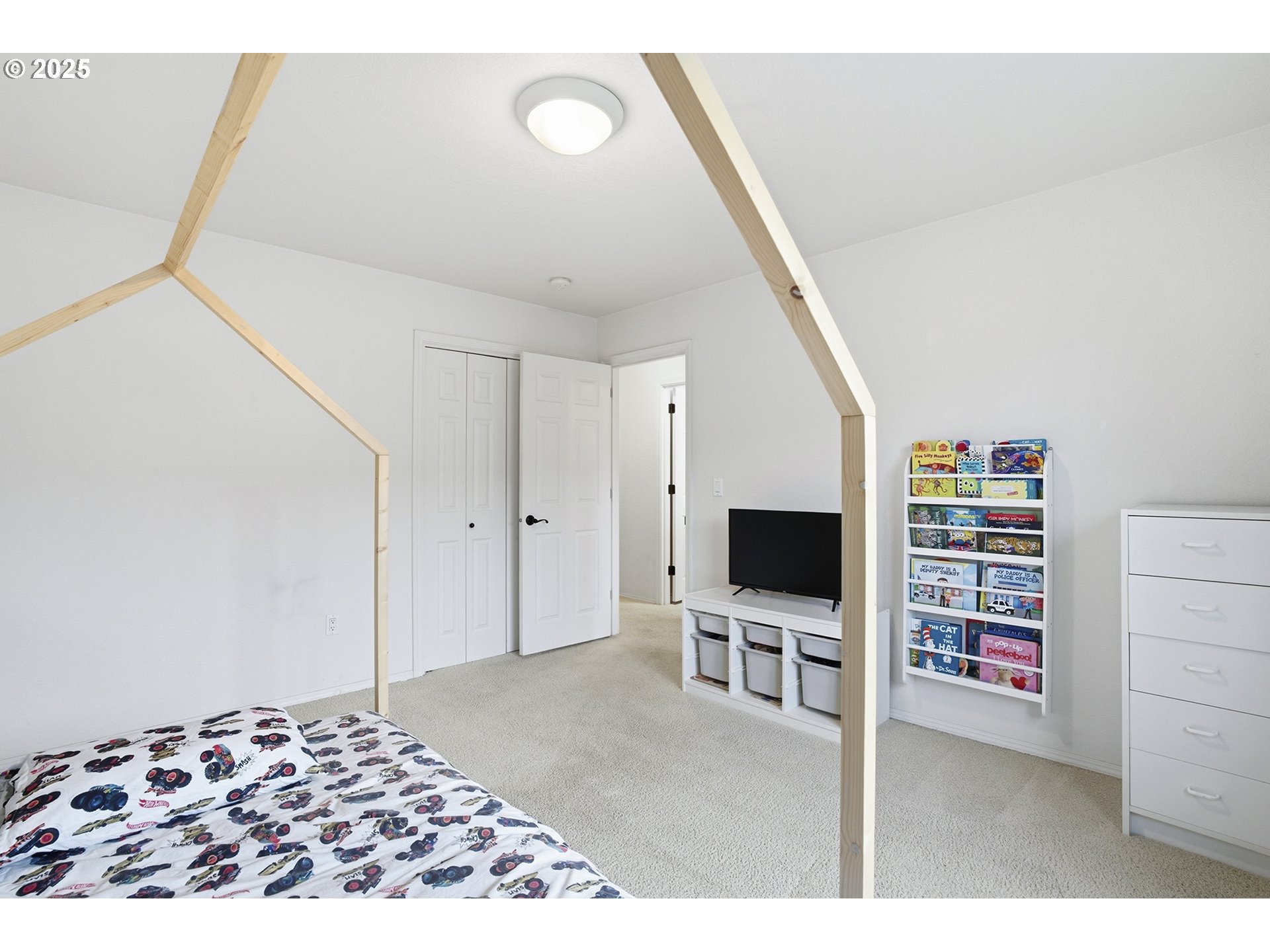445 Harris Lane Oregon City, OR 97045 - Photo 22 of 29 a living room with a flat screen tv and a bookshelf
