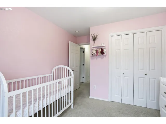 a view of a bedroom with wooden floor