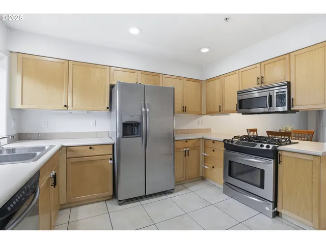 a kitchen with a sink a stove a refrigerator a window