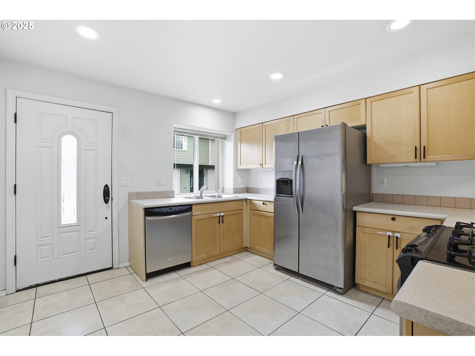 445 Harris Lane Oregon City, OR 97045 - Photo 5 of 29 a kitchen with a refrigerator sink and cabinets