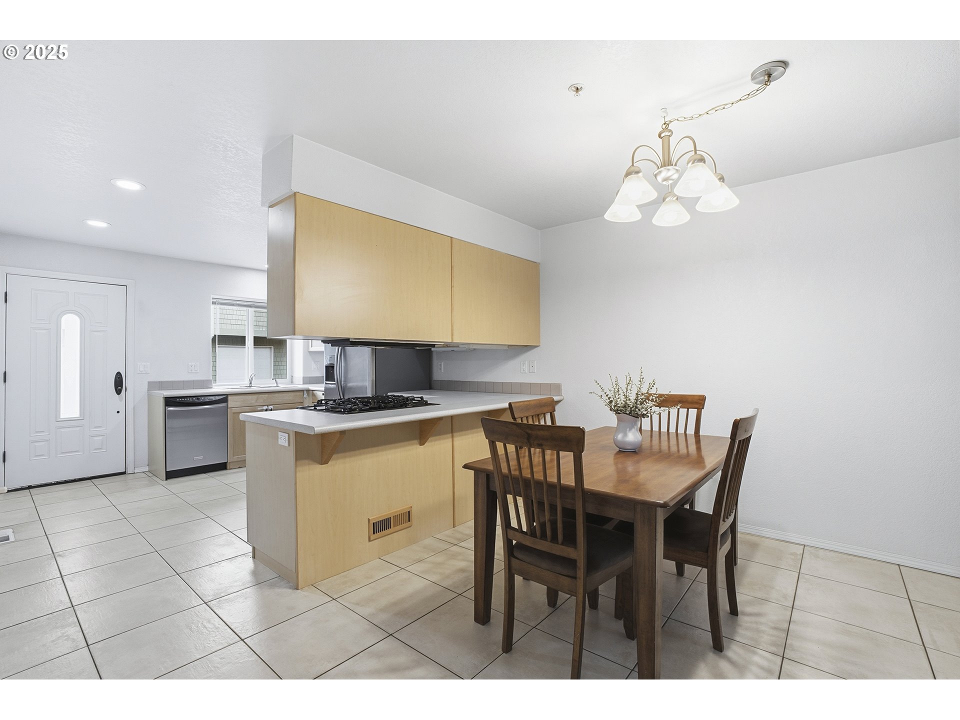 445 Harris Lane Oregon City, OR 97045 - Photo 7 of 29 a kitchen with stainless steel appliances kitchen island granite countertop a table chairs sink and cabinets