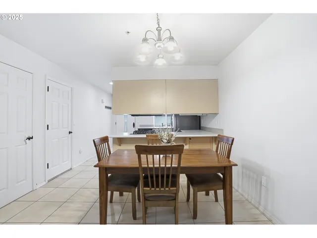 a view of a dining room with furniture and chandelier