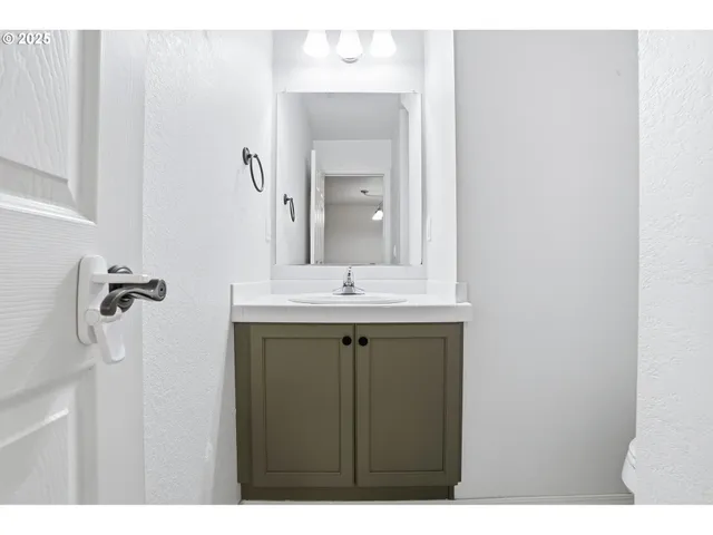 a bathroom with a sink vanity and mirror