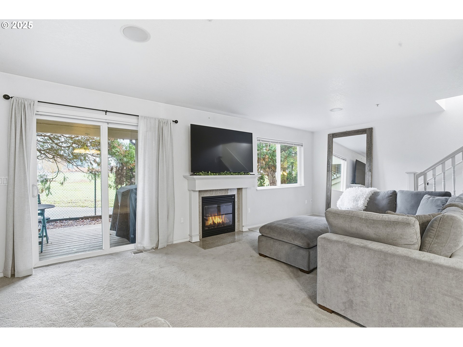 445 Harris Lane Oregon City, OR 97045 - Photo 10 of 29 a living room with furniture a flat screen tv and a fireplace